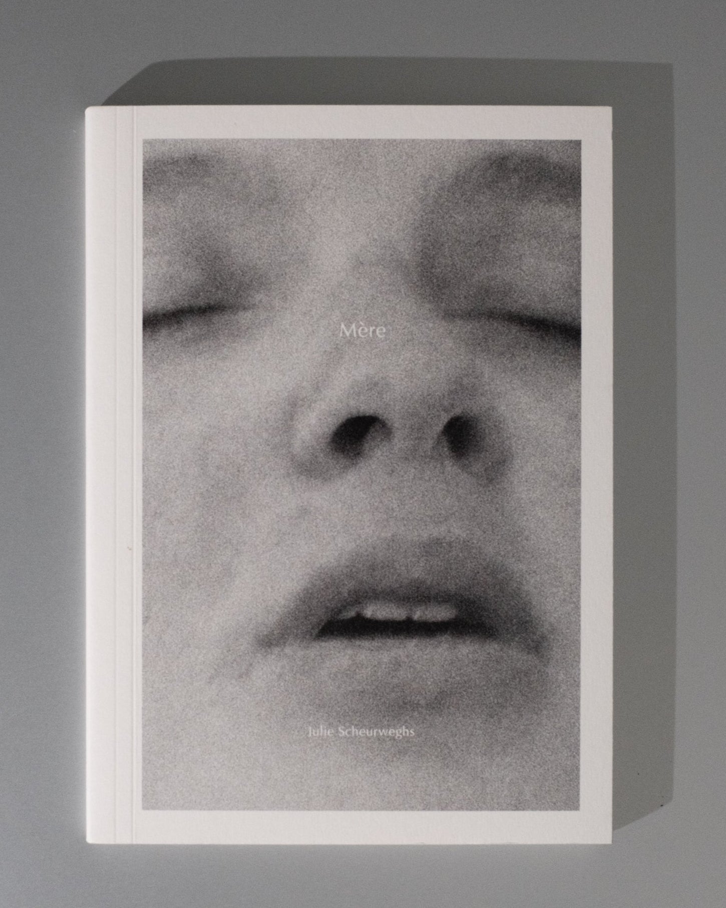 Framed black and white portrait of a person with closed eyes on a gray background