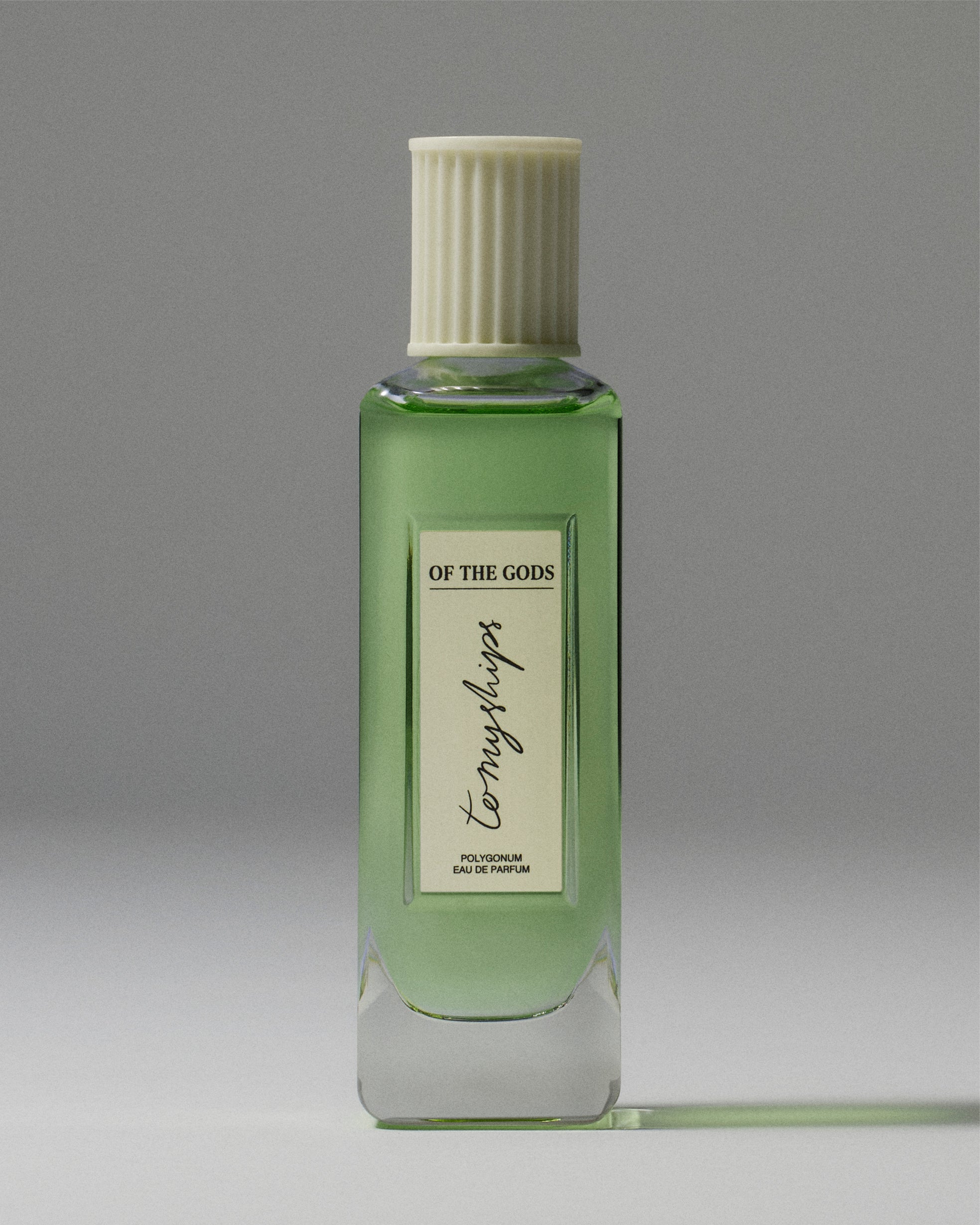 Green perfume bottle with a white cap on a gray background