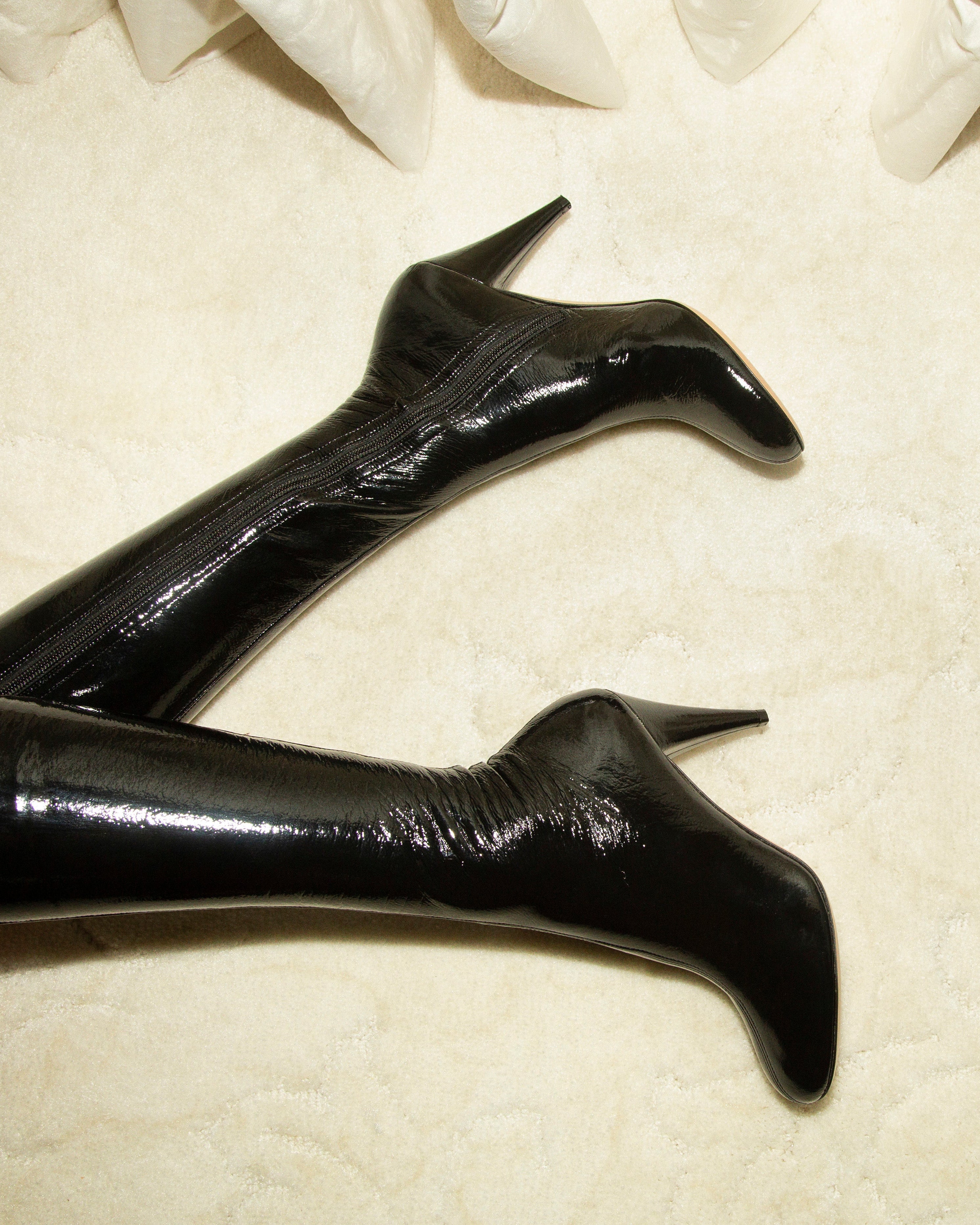 Black high-heeled boots on a light background