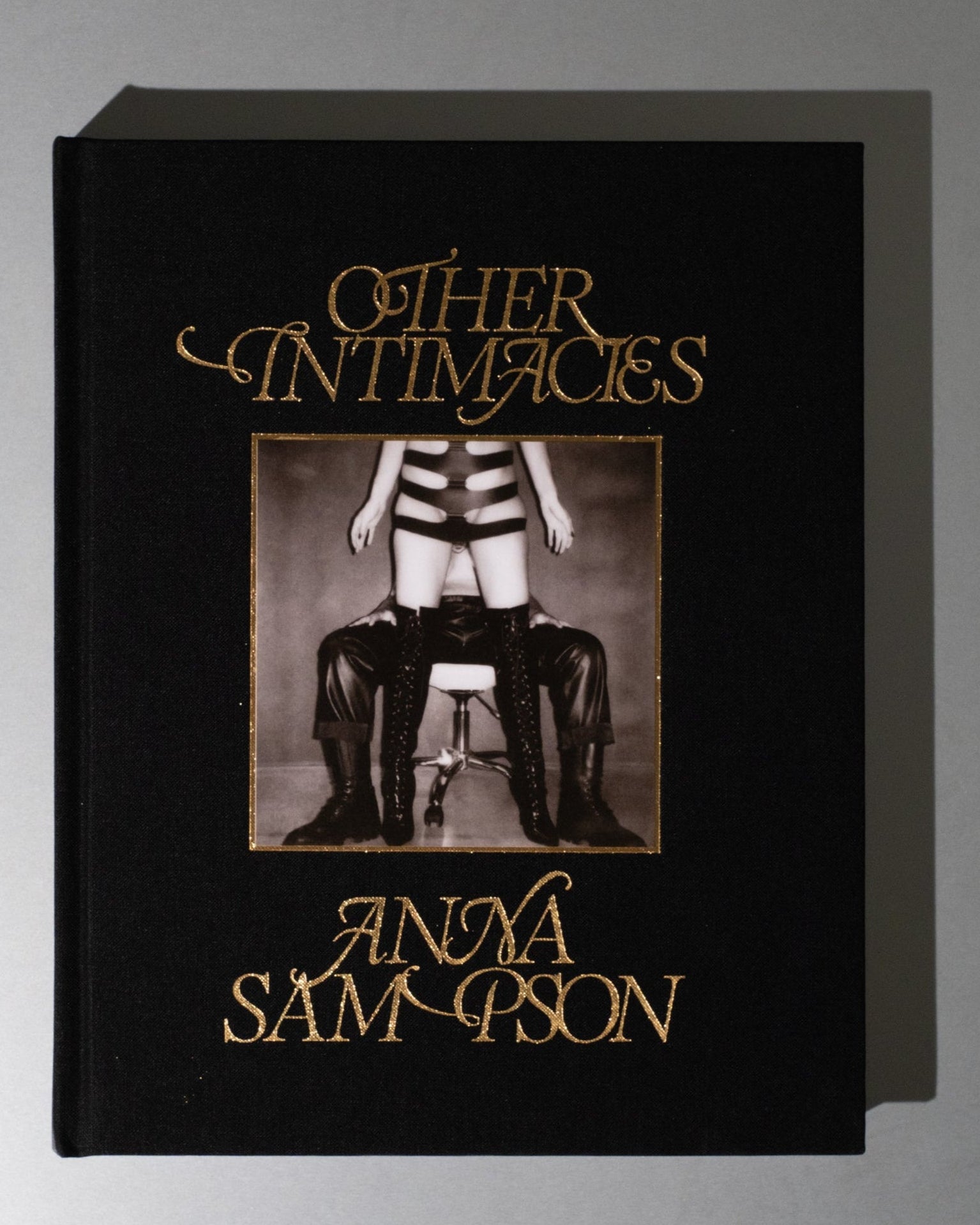 Book titled 'Other Intimacies' by Anya Samson on a gray background