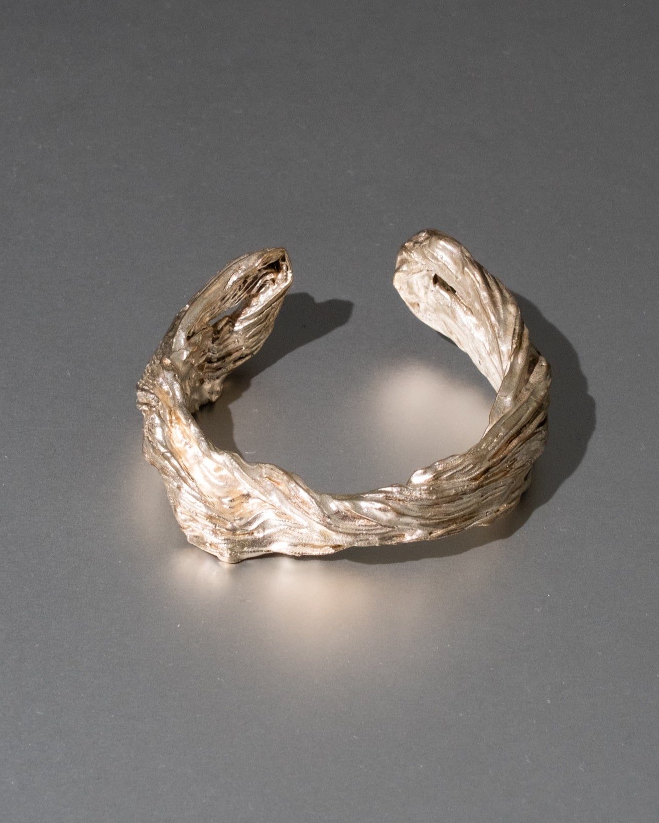 Silver bracelet on a gray background