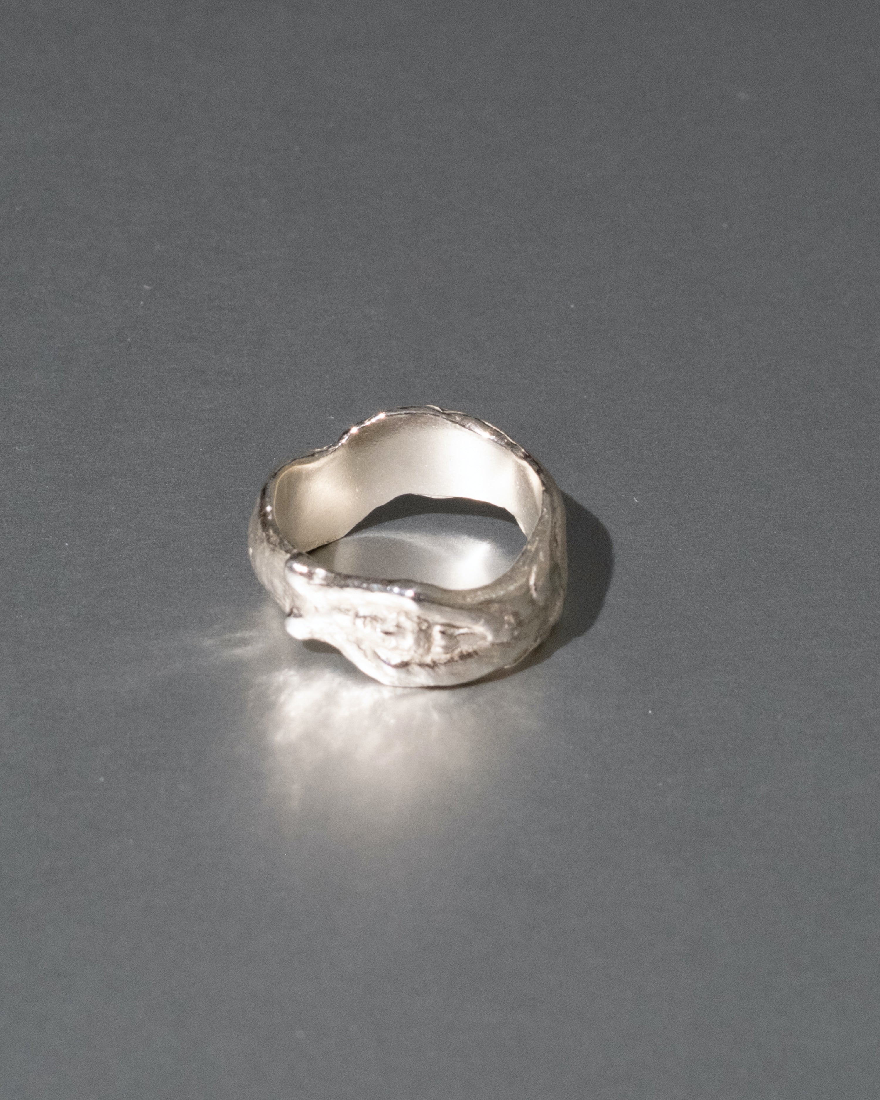 Silver ring on a gray background