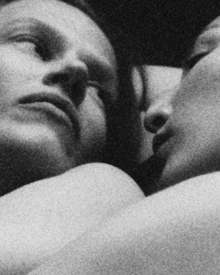 Close-up of two people embracing, with a focus on their faces.